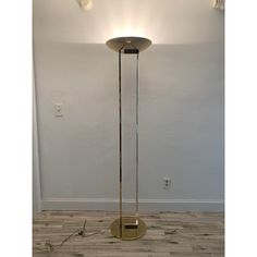 the floor lamp is standing alone in the room with no one around it and there are two lights on either side