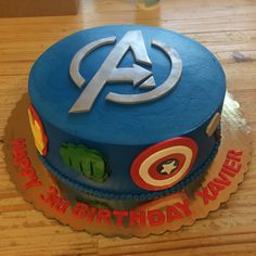 a birthday cake with the avengers symbol on it