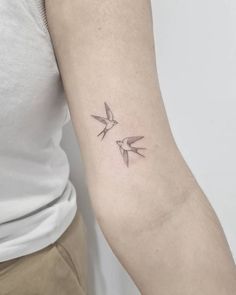 two birds tattoo on the left arm