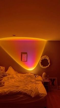 a room with a bed and some lights on the wall above it in front of a mirror