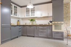 a kitchen with gray cabinets and white appliances