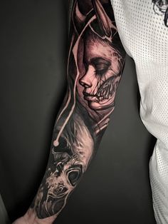 a man's arm with a tattoo on it that has a skull and a demon