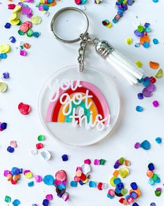 a glass keychain with the words you got this on it and a rainbow