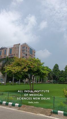 an image of a building that is in the middle of a field with trees and grass