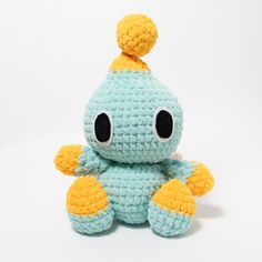 a small crocheted stuffed animal with big eyes