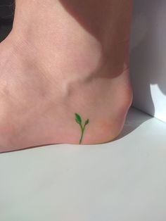 Leaf growing from heel tattoo idea I Am Rooted But I Flow Tattoo, Plant Tattoo Aesthetic, Water Plant Tattoo, Interesting Tattoo Placement, Green Thumb Tattoo, Small Atla Tattoo, Plant Based Tattoo, Growing Tattoo Ideas, Leaf Tattoo Small