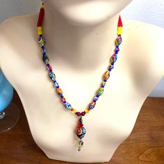 Vintage Beautiful Milifiori glass Beaded Necklace with easy on toggle Clasp. This Upscale Bright and bold piece has quality hand blown glass beads with abstract pressed fused florals. The Dangle Chandelier Pendant adds such a stylish interest! Would accessorize any clothing style with unique charm. Would look fantastic on a crisp white collared blouse. Measures 17" in length, pendant drops 2" and is 3/8 round. In new condition without any wear. Gifts for girlfriend, gift for BFF, gifts for Amon, fashionista gifts, eclectic gifts, fashion costume jewelry, contemporary jewelry. Artistic Multicolor Beach Jewelry, Colorful Adjustable Glass Beaded Necklaces, Bohemian Murano Glass Beaded Necklace Gift, Traditional Adjustable Glass Beaded Necklaces, Artisan Multicolor Glass Beaded Necklaces, Artistic Adjustable Beaded Necklaces For Festivals, Handmade Multicolor Murano Glass Beads, Bohemian Multicolor Murano Glass Beaded Necklace, Artisan Multicolor Glass Beads