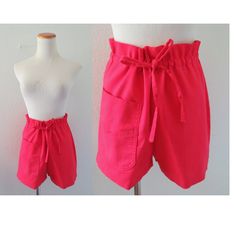 "Vintage red high waisted paperbag waist shorts from the 1960s / 1970s. Details: - solid red color - drawstring paperbag style waist - one front pocket - cotton blend - no tags - estimated size is women's medium - some light spots on front, otherwise good pre-owned condition Measurements: - waist: up to 16\" (32\" doubled) maximum, can be cinched smaller - shown on a mannequin with a 26\" waist - hips: 18\" / 36\" doubled - inseam: 2\" - rise: 13\" - leg opening: 11\"" 60s Shorts, Drawstring Waist Shorts, Light Spots, Solid Red, Red High, 60s Fashion, Vintage Clothing, Short Outfits, Drawstring Waist