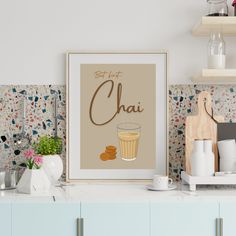 a kitchen counter with a framed poster on it