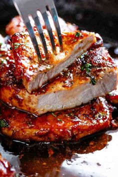 a fork sticking out of some meat on a pan