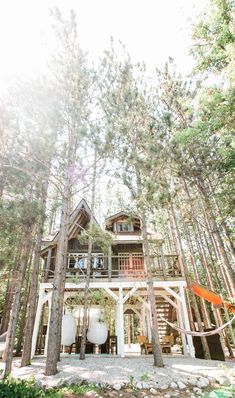 a house in the woods surrounded by trees