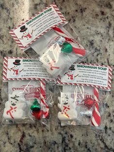 four packaged christmas candies sitting on top of a counter