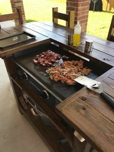 an outdoor bbq grill with food on it