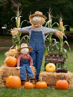 scarecrows and hay bales with pumpkins on the ground in front of them