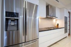 a kitchen with stainless steel appliances and white cabinets