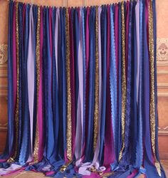 purple, blue and gold drapes hanging from a wall