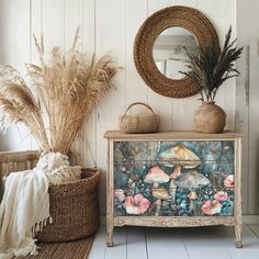 an old dresser with flowers and mushrooms painted on the front is surrounded by wicker baskets