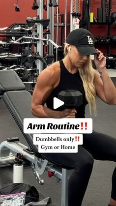 a woman sitting on top of a bench in a gym