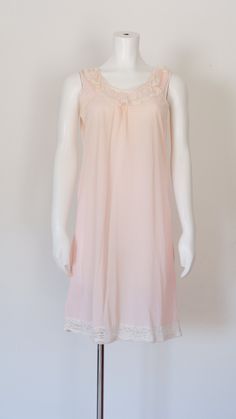 Cute vintage pink nightgown Pink nylon fabric Lace neckline Super cute! **See condition** Measurements: Best fits - Small  Width - 34" Length - 35.5"  Condition - Good - Has been repaired along the back seam, minor snags to nylon Label - None *All measurements are taken in inches. Please compare and ensure fit of item before purchase. Please feel free to contact me with any questions. Looking for more lingerie? Check out these listings: https://www.etsy.com/shop/flatlandfinery?section_id=1848028 Pink Night Gown, Pink Nightgown, Dress With Lace Trim, Nylon Dress, Women's Nightgowns, Lace Neckline, Nightgowns, Dress With Lace, Vintage Pink