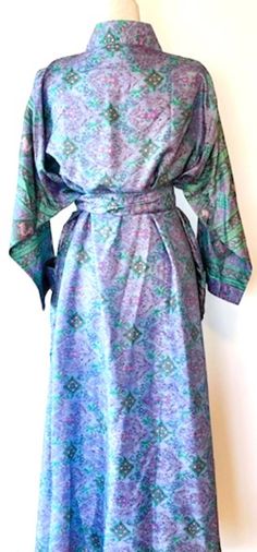 Luxury Silk Kimono Duster: Elegant. This Kimono has a beautiful finish, printed on a classic patern. Creates depth, interest, and designer appeal. Luxurious fabric, soft, opaque. The perfect duster for cocktail parties, resort, beach or poolside cover-up. Adapts well to a duster coat or dress.A stunning mix of deep contrasting colors, turquoise and black. Engineered border adds designer elements to this duster. Great gift for Easter, Mother's Day, Birthday, or just because you deserve it. Fabric Fitted Silk V-neck Kimono, Fitted Silk Bohemian Kimono, Elegant Multicolor Printed Kimono, Elegant Long Purple Kimono, Fitted Silk Kimono With Floral Print, Elegant Long Sleeve Printed Kimono, Fitted Multicolor Silk Kimono, Elegant Fitted Kimono With Floral Print, Elegant Purple Dress With Kimono Sleeves