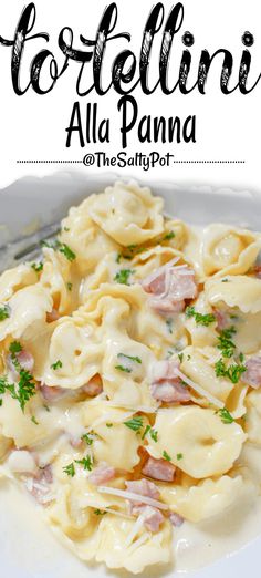 pasta with ham and parsley in a white sauce on a plate next to a fork