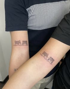 two people with matching tattoos on their arms