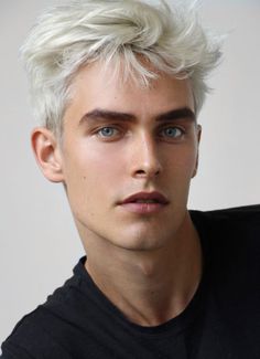 a young man with white hair and blue eyes