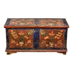 an old painted chest with flowers on it