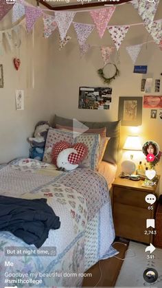 a bed room with a neatly made bed and lots of decorations on the wall above it