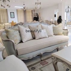 a living room filled with lots of white furniture