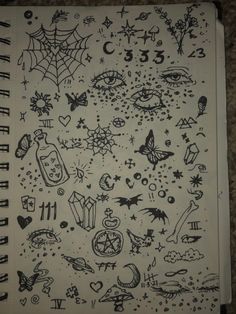 an open notebook with black and white drawings on it's cover, which has various symbols