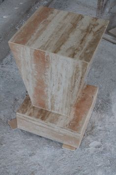 a marble bench sitting on top of a cement floor