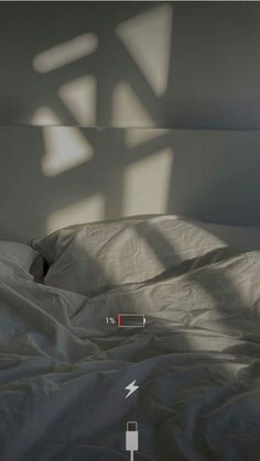 the bed is unmade and has white sheets on it, with an arrow pointing to the left