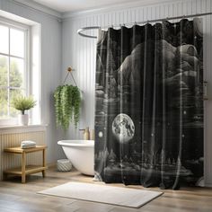 a black and white shower curtain with an image of the moon in the night sky