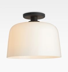 a light fixture with a white shade on the top and black trim around the bottom