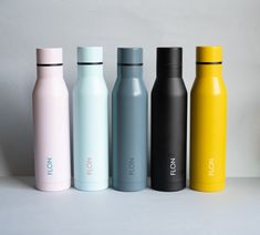 four different colored stainless steel water bottles lined up