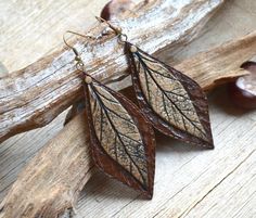 Chestnut brown and bronze nature inspired earrings are made of polymer clay using the rich leather texture and the real leaf imprint. They definitely will not allow its owner to remain unnoticed. The earrings are made in warm earth tones that remind us about autumn fall. The earrings are large, but Elegant Hand-tooled Brown Jewelry, Elegant Hand Tooled Brown Jewelry, Brown Leather Jewelry With Patina, Leaf-shaped Brown Earrings Gift, Brown Leaf-shaped Earrings For Gift, Brown Leaf-shaped Earrings Gift, Brown Leaf-shaped Jewelry For Gift, Brown Patina Jewelry For Gifts, Bohemian Brown Leaf-shaped Earrings