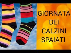 two pairs of colorful socks hanging from the side of a building with text reading giornata dei calzzini spaati