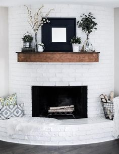 an instagram page with a fireplace and potted plants on the mantel above it