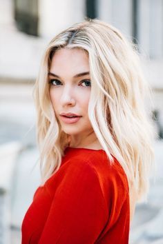 a woman with blonde hair is posing for the camera