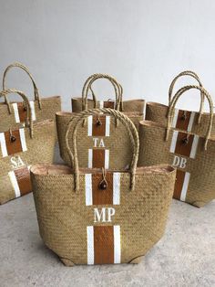 six brown and white bags with the letters mmp on them sitting on a table