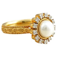 Gold(14K): 6.50g Brilliant cut Diamonds (VS clarity & H-I colour): 0.26ct Gemstone: Cultured Pearl Classic and evergreen, the Zoe ring has been handcrafted in gold and holds a white cultured pearl at its heart. The prong-set diamonds surrounding the pearl add to its elegance and sophistication. Luxury Pearl Ring For Anniversary With Intricate Design, Luxury Stackable Yellow Gold Pearl Ring, Luxury Heirloom Pearl Ring With Polished Finish, Luxury Pearl Ring With Center Stone For Anniversary, Luxury Pearl Gemstone Ring For Anniversary, Diamond And Pearl Ring, Pearl And Diamond Ring, Pearl Cluster, Diamond Cluster Ring