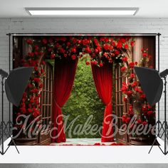 an open stage with red curtains and roses on the curtain is shown in front of a white brick wall