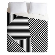 a black and white striped bed with two pillows on top of the pillowcases