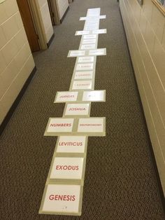 a long hallway with several signs on the floor