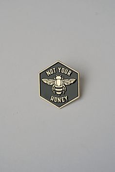 a black and gold bee pin with the words not your honey on it