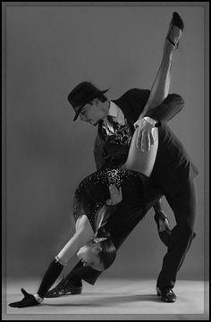 a man and woman are dancing together on a blue background