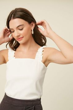 ruffle knit tank top Trendy White Ruffled Tank Top, Ruffled Tank Top With Tank Straps For Spring, Elegant Ribbed Tank Top For Summer, Elegant Ribbed Summer Tank Top, White Fitted Tank Top With Ruffled Straps, White Feminine Tank Top With Ruffled Straps, Feminine Tank Top With Ruffled Straps, White Ruffled Camisole For Brunch, Chic White Ruffled Tank Top