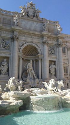 an ornate building with statues and fountains in front of the entrance to the water fountain