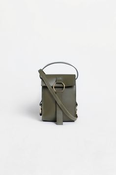 Our MINI BAG in olive green is a perfect mixture of elegance and distinctiveness. 
Straight design and much love for detail will immediately make the MINI BAG your daily companion. From a busy work day to Happy Hour - it holds all your everyday essentials. The matching cross-body strap that comes with the bag makes it the perfect everyday handbag. Green Satchel Phone Bag For Everyday, Green Phone Bag With Adjustable Strap For On-the-go, Green Phone Bag With Detachable Strap For Travel, Green Leather Phone Bag With Adjustable Strap, Chic Green Phone Bag With Removable Pouch, Green Phone Bag With Adjustable Strap For Everyday Use, Chic Green Phone Bag For Travel, Chic Green Travel Phone Bag, Chic Green Phone Bag